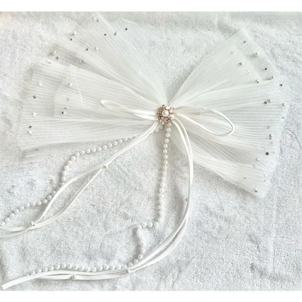 White sheer pleated bow with rhinestone and pearl embellishment